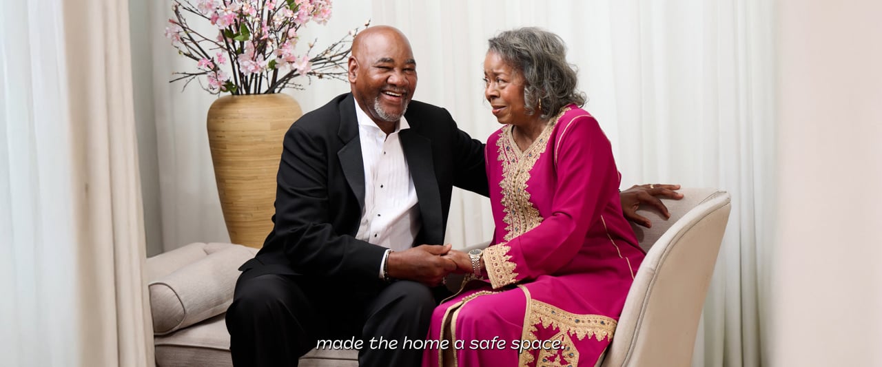 A couple laughing together in their home